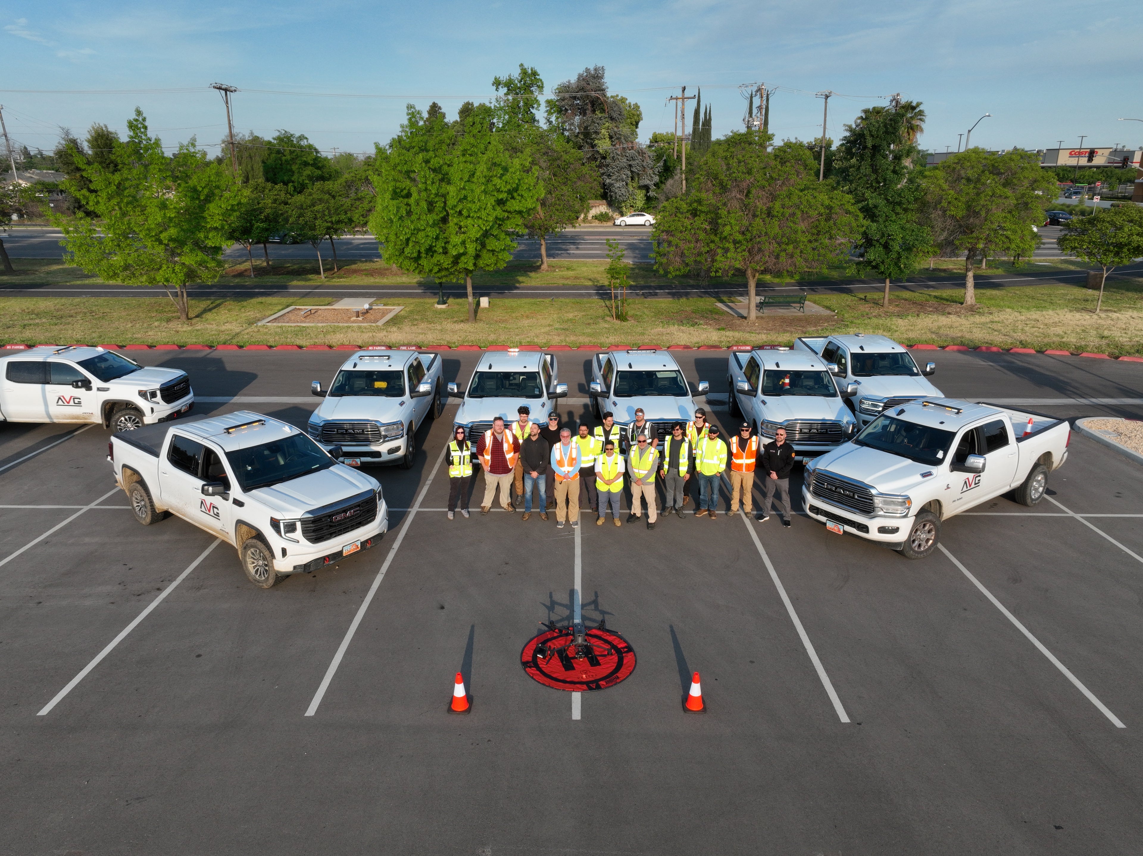 Group of people surrounded by trucks from a drone POV. 