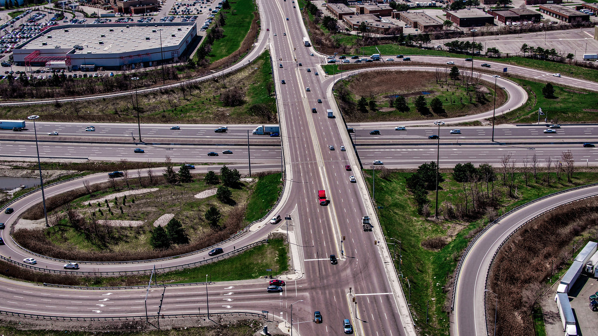 Aerial view of a multi-lane highway intersection with vehicles.