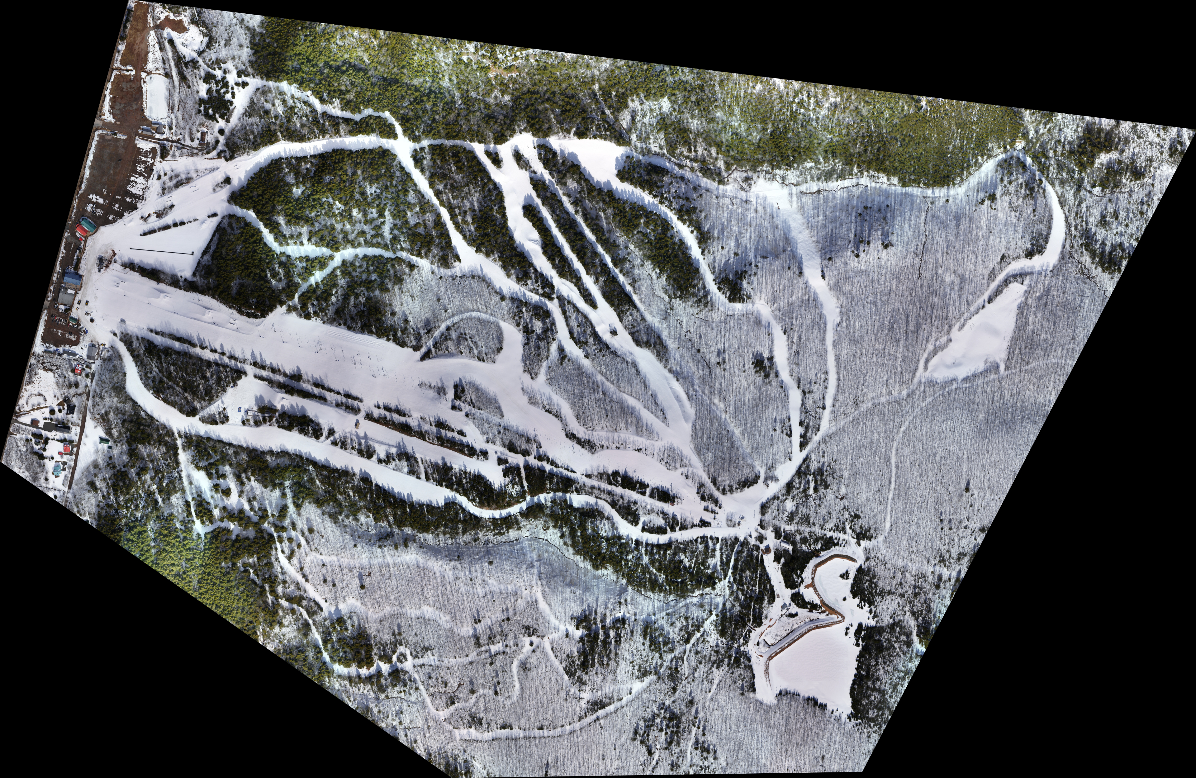 Aerial view of a snowy landscape with ski tracks