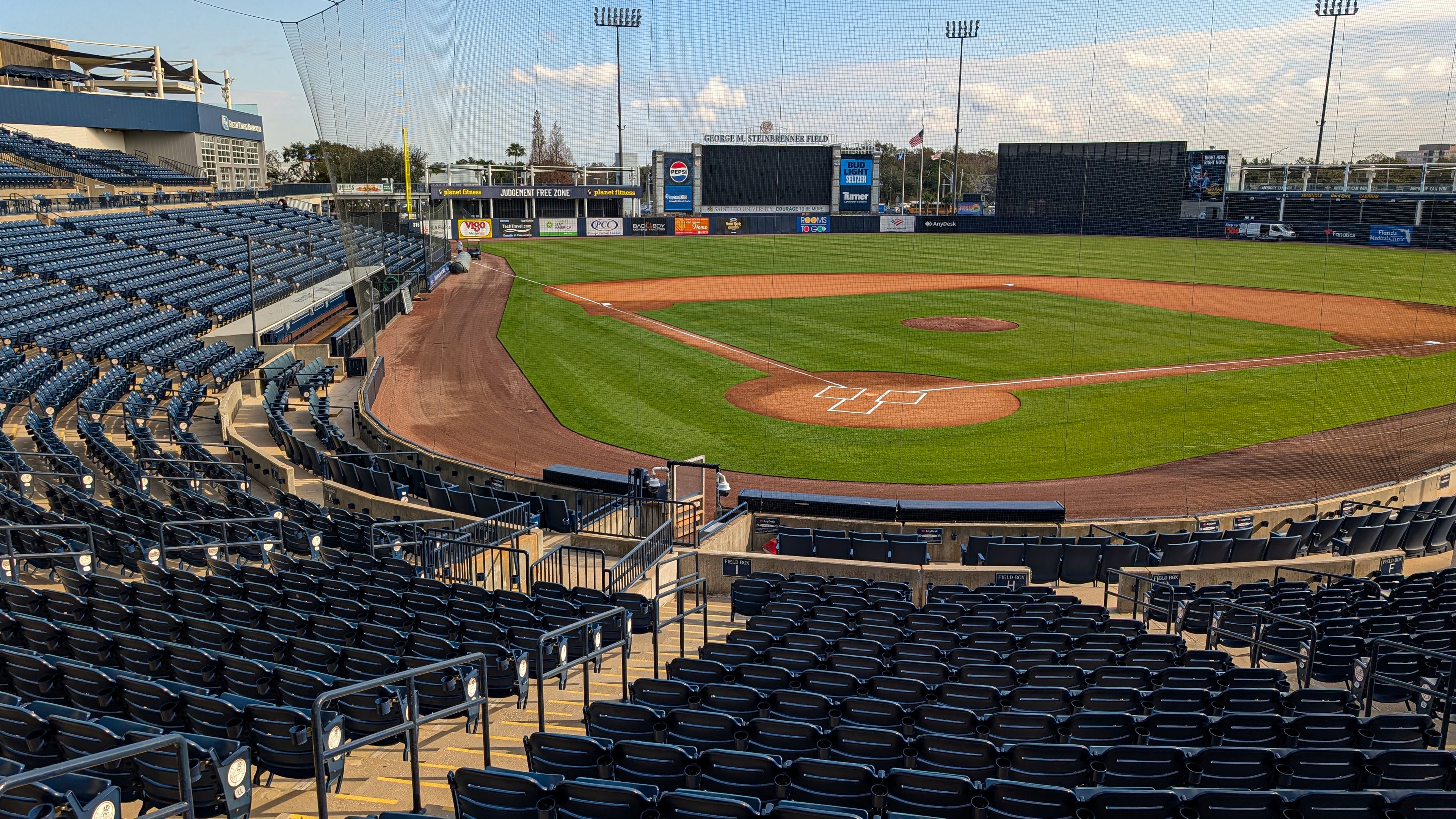 Baseball stadium with empty seats and a clear sky